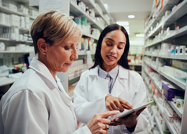 2 pharmacists with a tablet in the medication storage room 