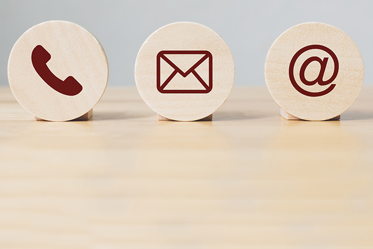 Wooden discs with symbols for telephone, letter, and email